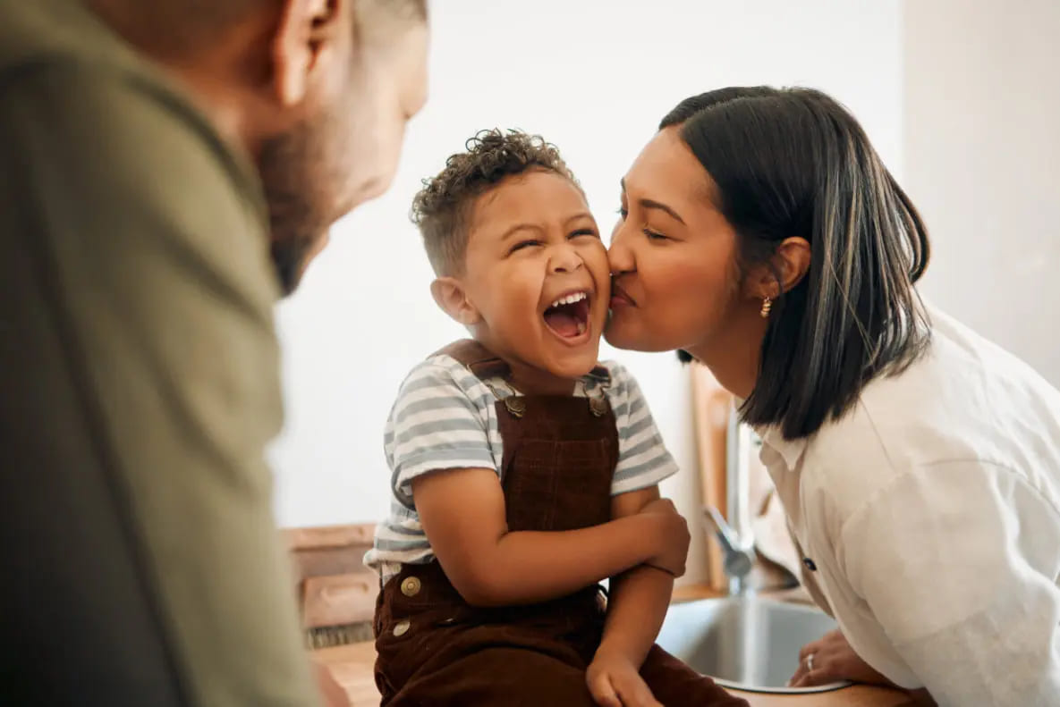 Happy divorced parents with their child after reaching a co-parenting agreement
